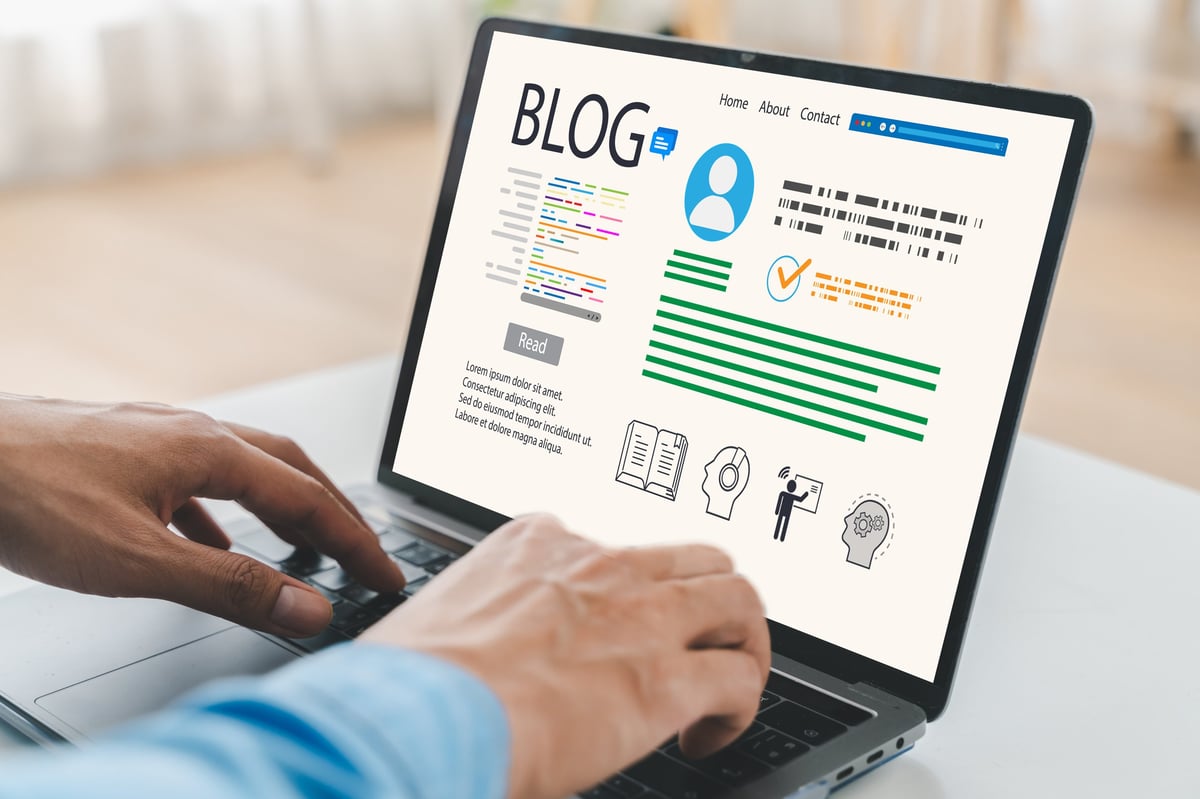 Professional content creator typing on a laptop writing a blog article